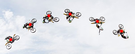 Composite photograph of a jumping motorbike tracing out a parabolic arc in the sky.